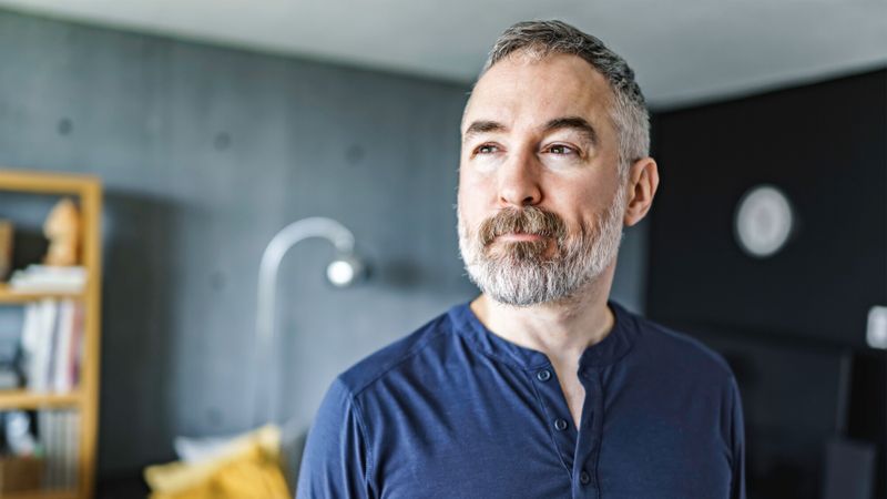 homme barbu dans son salon